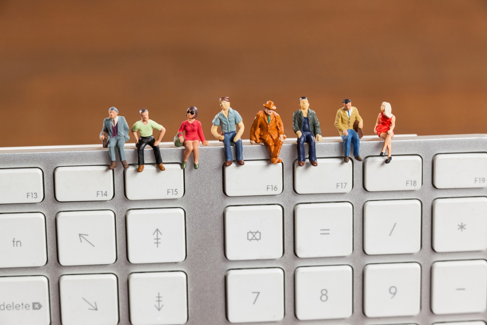 miniature-people-sitting-top-keyboard.jpg